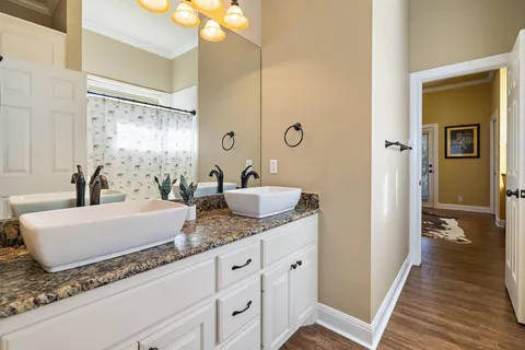 a bathroom with a granite countertop sink and a mirror