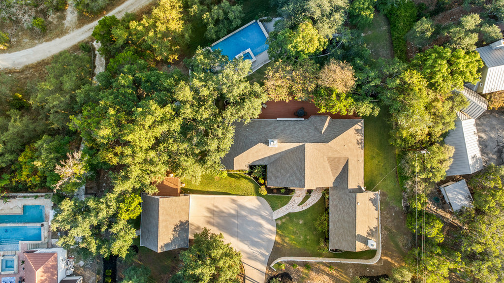 3507 Bee Creek Road Spicewood, TX 78669 - Photo 3 of 40 an aerial view of a house with a yard and trees