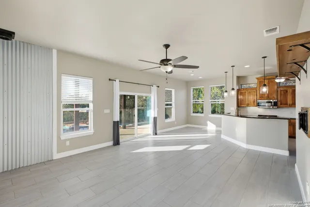 a view of a kitchen with a sink and dishwasher a refrigerator with wooden floor
