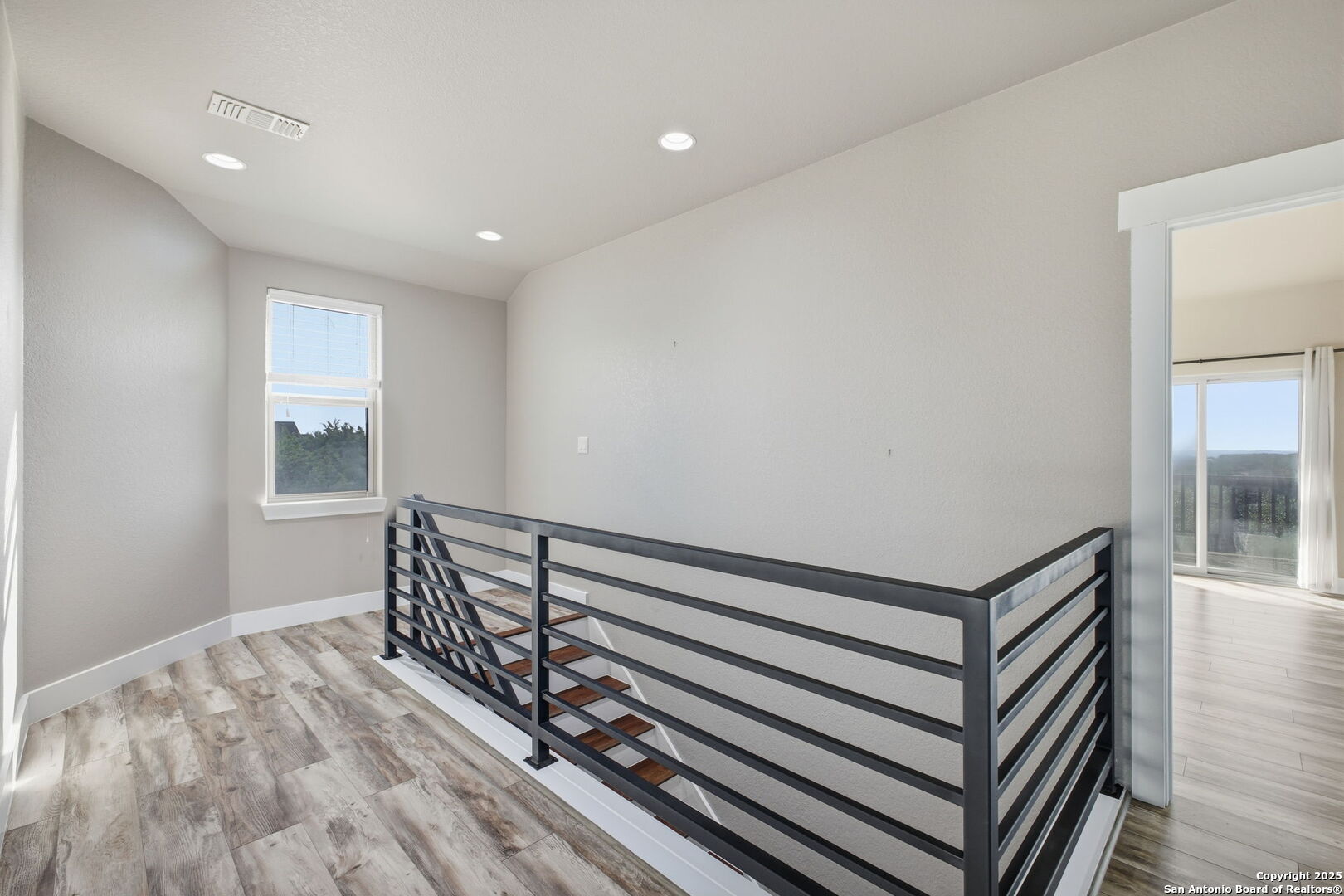1275 Mystic Breeze Spring Branch, TX 78070 - Photo 20 of 50 a view of a hallway with wooden floor and staircase