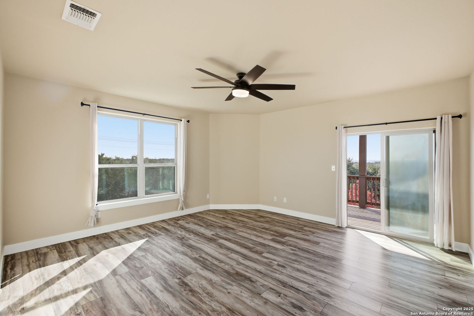 1275 Mystic Breeze Spring Branch, TX 78070 - Photo 21 of 50 a view of an empty room with a window and wooden floor