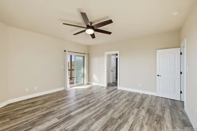 a view of a livingroom with a hardwood floor and a ceiling fan