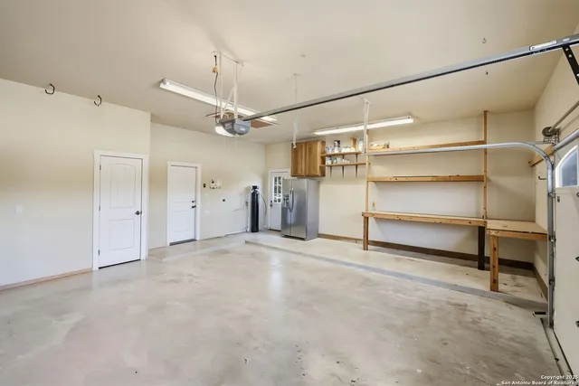 a view of an empty room with a ceiling fan