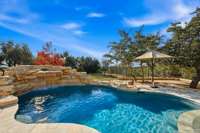 a view of a swimming pool with an outdoor space and seating area