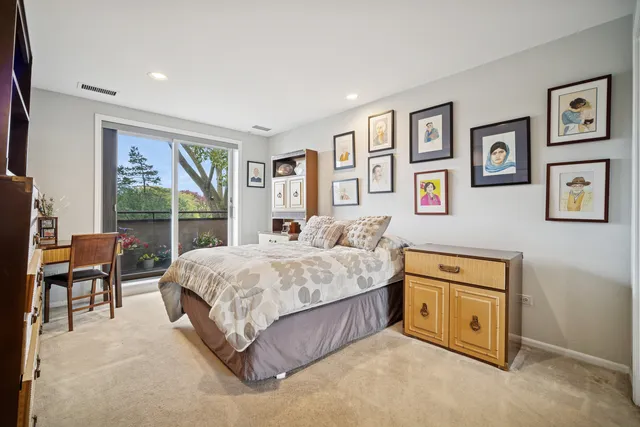 a spacious bedroom with a bed and a large window