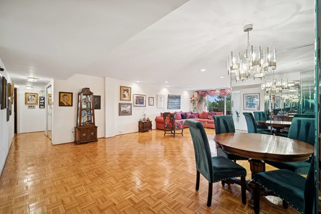 a view of a dining room with furniture and chandelier