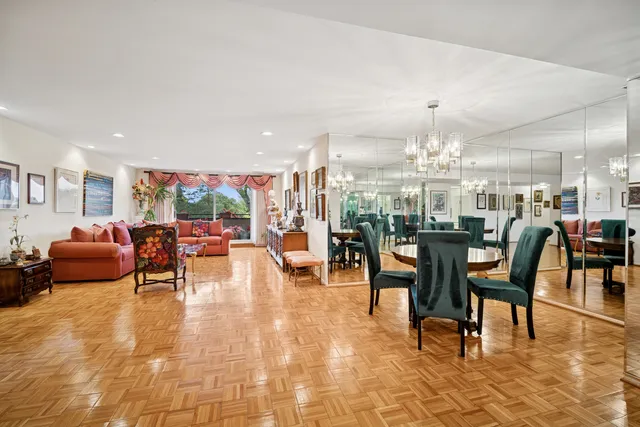 a living room with furniture and a chandelier