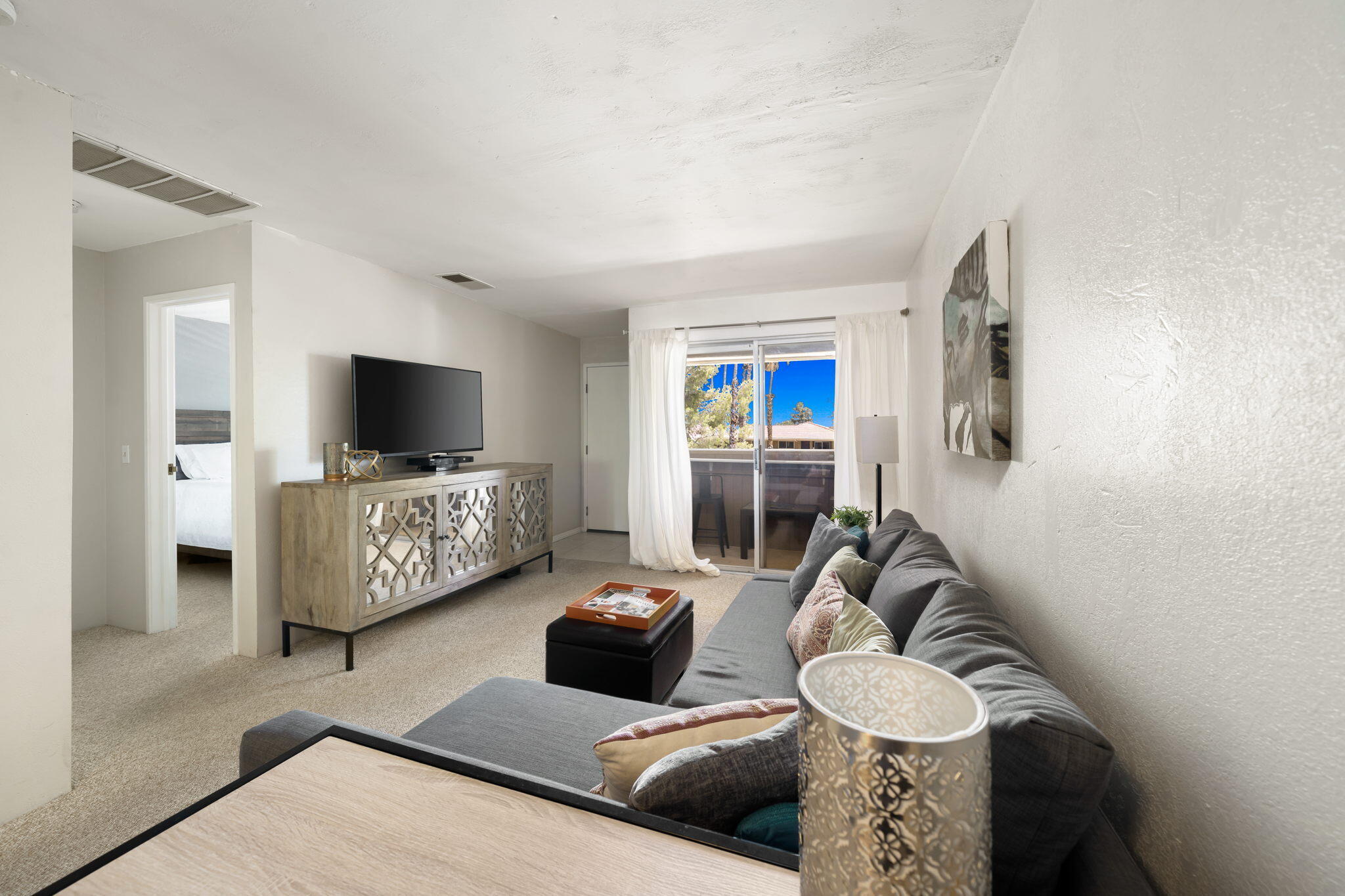 2860 North Los Felices Road, Unit 214 Palm Springs, CA 92262 - Photo 11 of 26 a living room with furniture and a flat screen tv