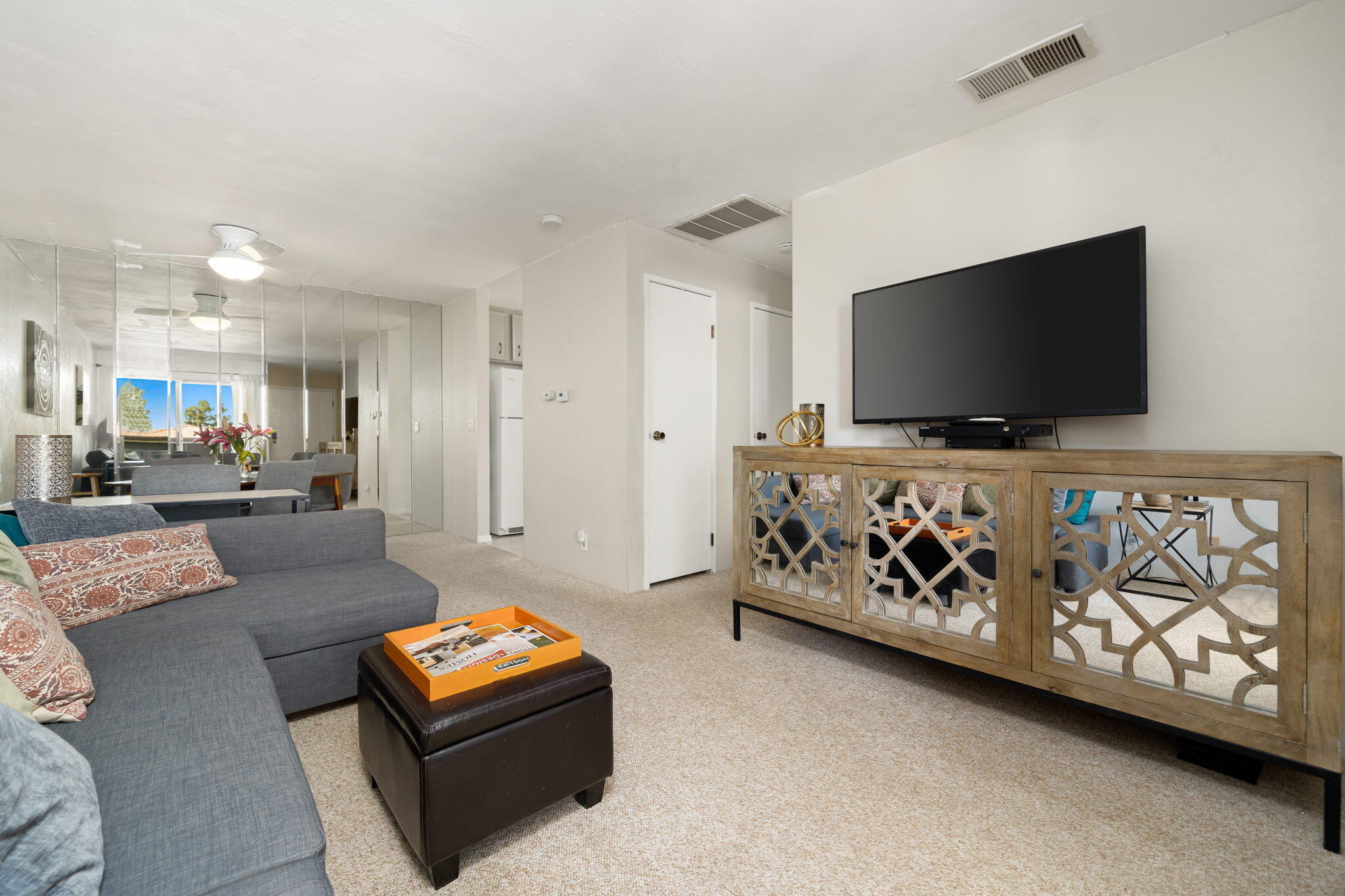 2860 North Los Felices Road, Unit 214 Palm Springs, CA 92262 - Photo 9 of 26 a living room with furniture and a flat screen tv
