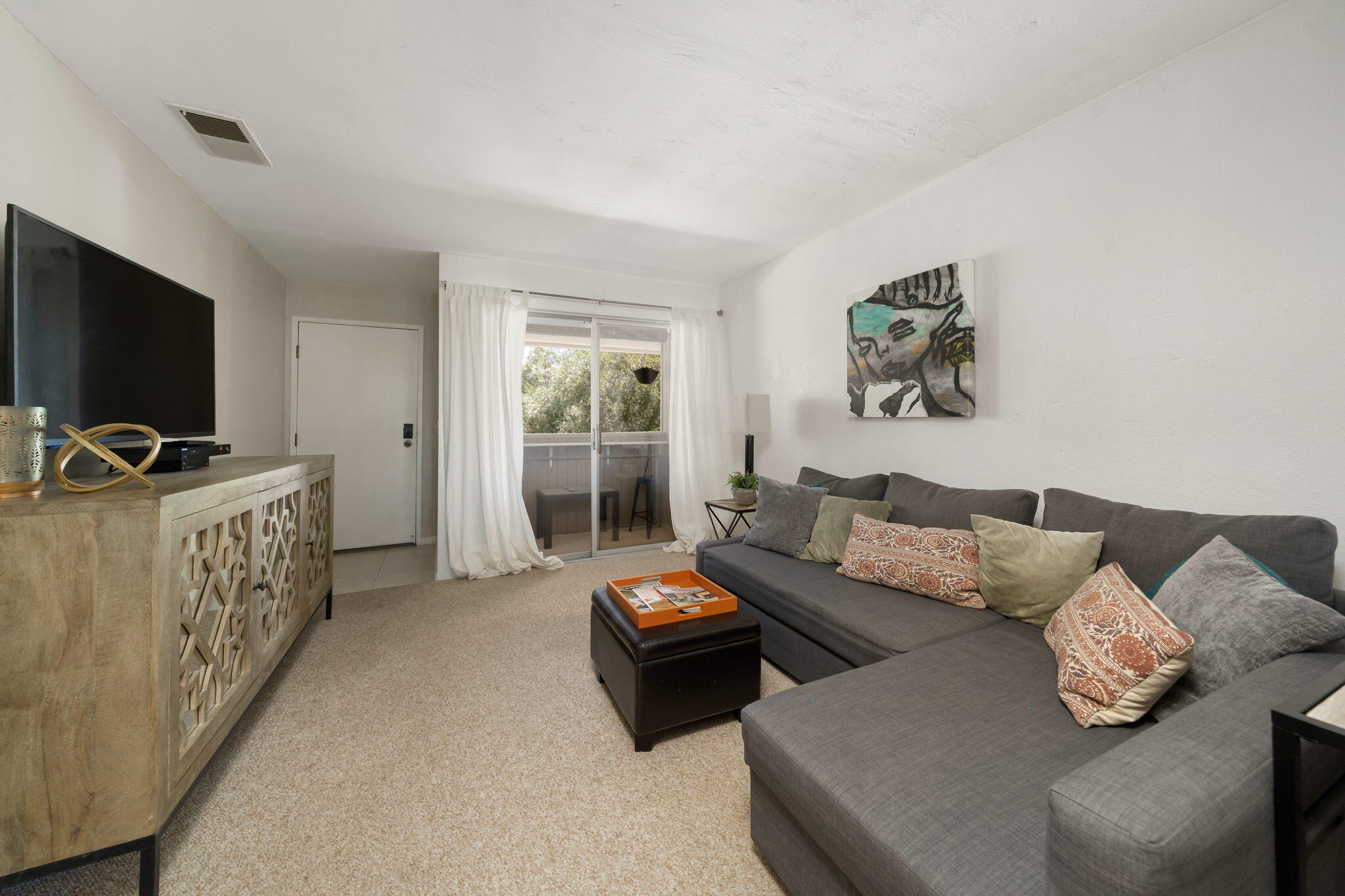 2860 North Los Felices Road, Unit 214 Palm Springs, CA 92262 - Photo 10 of 26 a living room with furniture and a flat screen tv