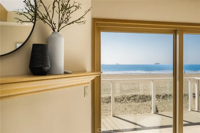 a view of a room that has a large window and a door