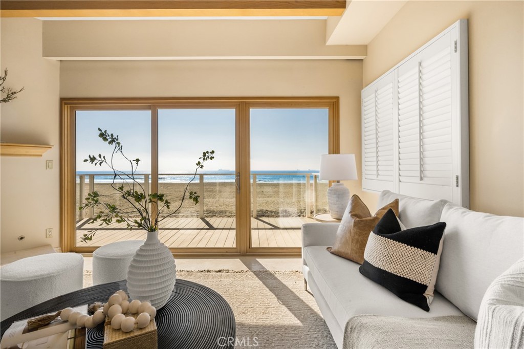 78 A Surfside Avenue Surfside, CA 90743 - Photo 17 of 45 a living room with furniture and a floor to ceiling window