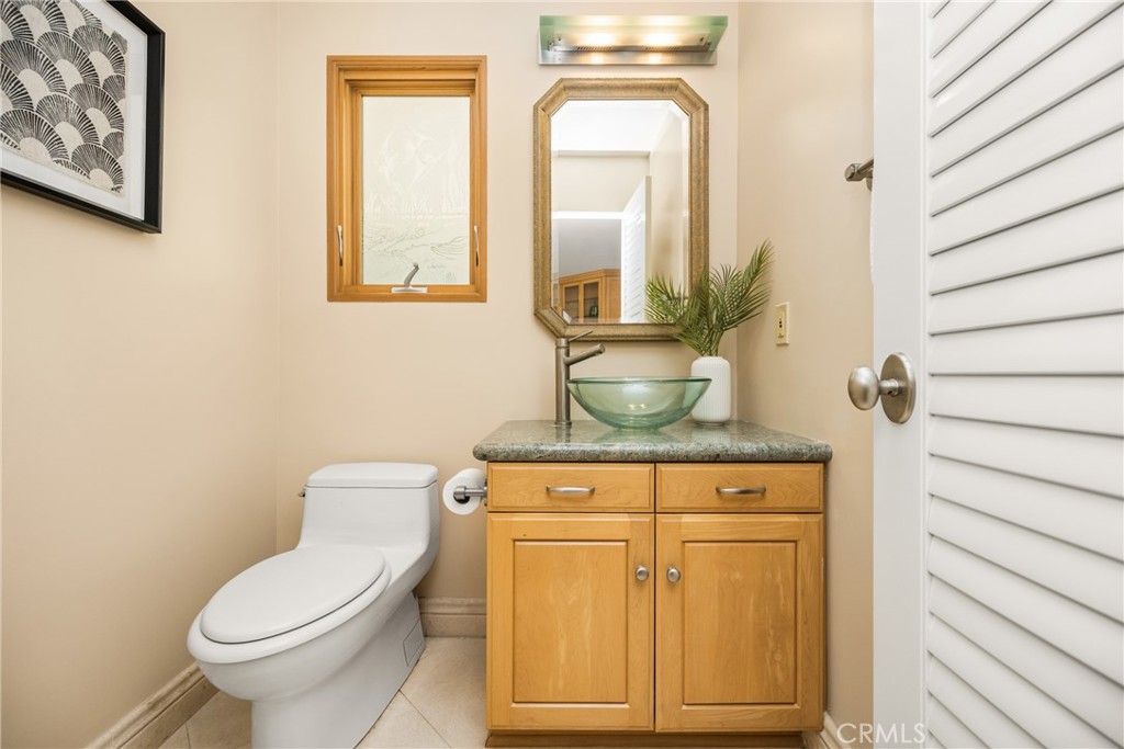 78 A Surfside Avenue Surfside, CA 90743 - Photo 18 of 45 a bathroom with a toilet a sink and mirror