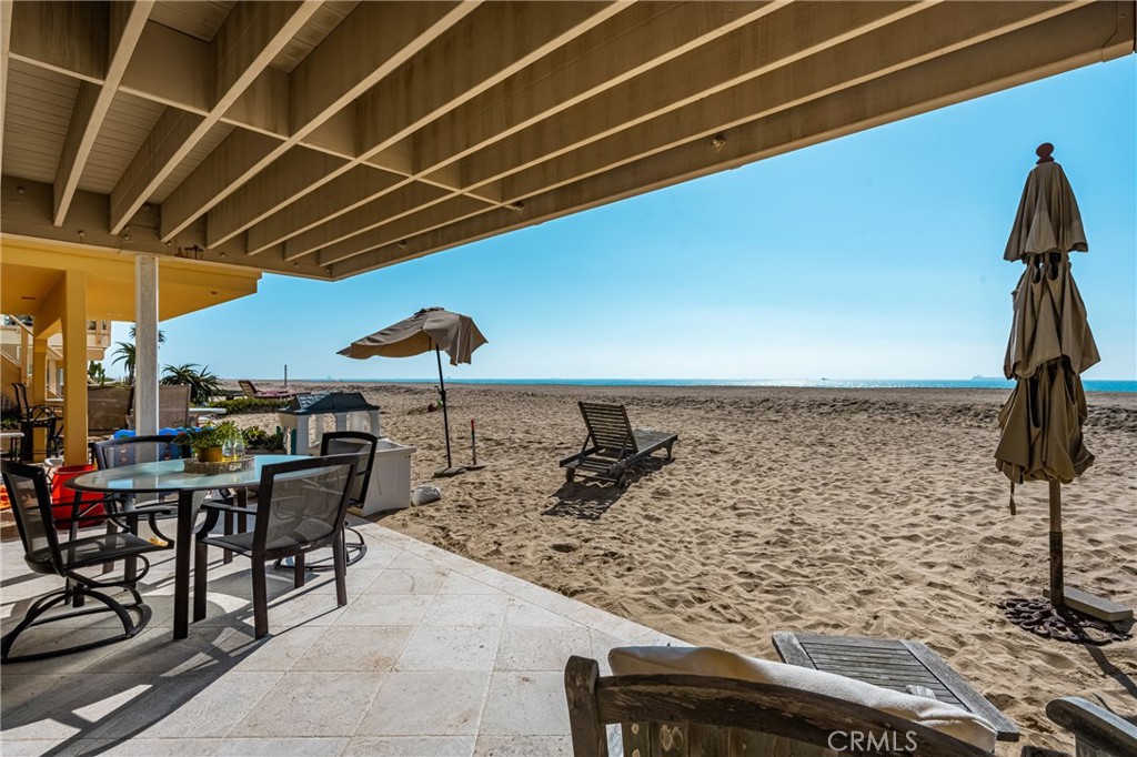 78 A Surfside Avenue Surfside, CA 90743 - Photo 41 of 45 a view of a patio with a table and chairs under an umbrella