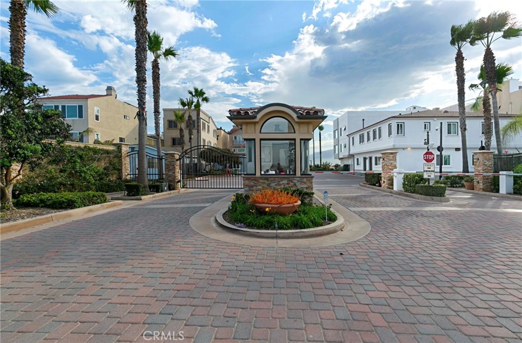 78 A Surfside Avenue Surfside, CA 90743 - Photo 42 of 45 a front view of a building with garden and trees