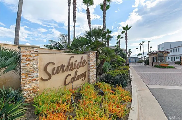 a street sign on a wall next to a road
