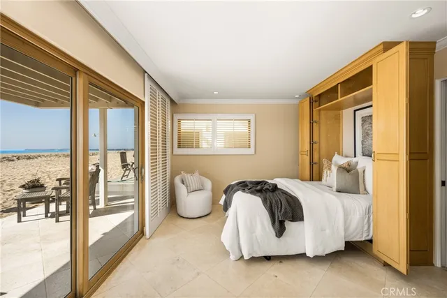 a bedroom with bed and glass door