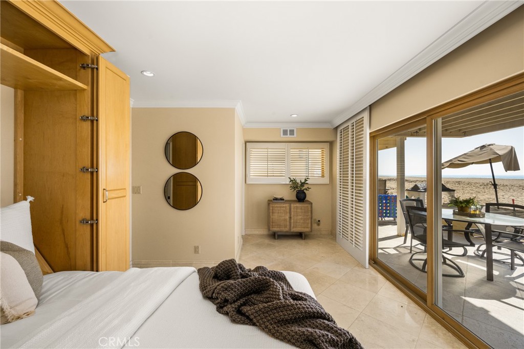 78 A Surfside Avenue Surfside, CA 90743 - Photo 6 of 45 a bedroom with a bed and glass walk in closet