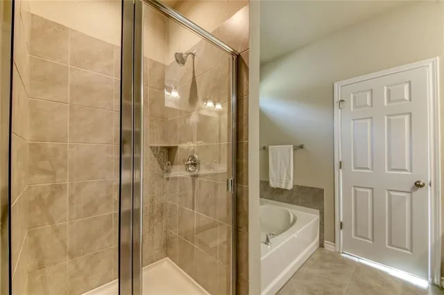 a bedroom with bed and a chandelier