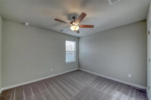 a en suite bathroom with a granite countertop sink and a mirror