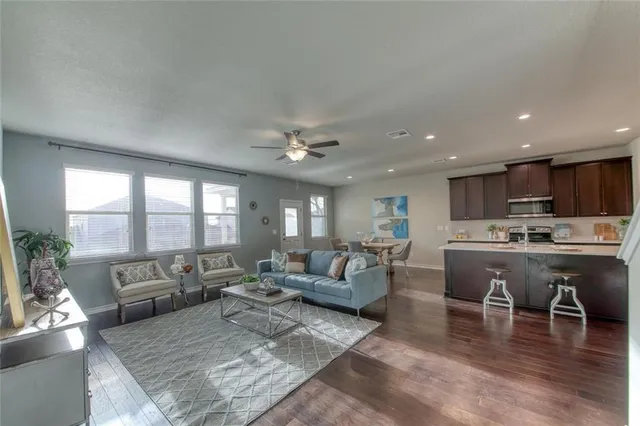 a kitchen with sink and view of living room