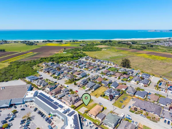 an aerial view of residential building and ocean