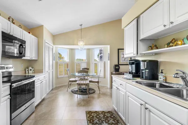 a kitchen with stainless steel appliances a stove a sink a refrigerator and cabinets