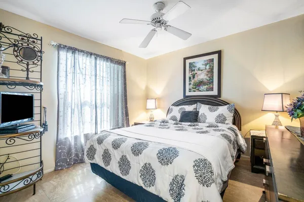 a bedroom with a bed and a flat screen tv