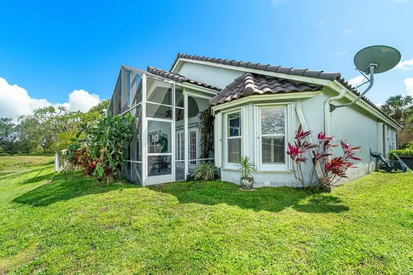a view of a house with a yard and porch