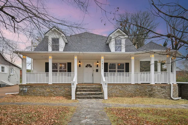 a front view of a house with a yard covered in snow