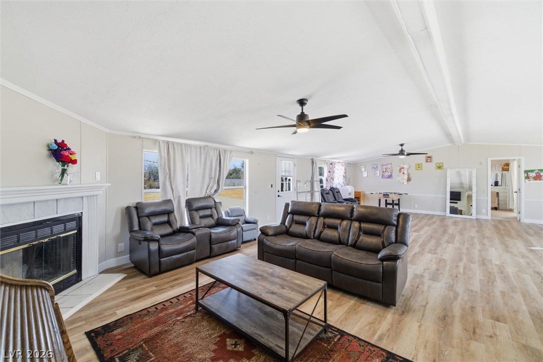 4331 Retread Road Pahrump, NV 89048 - Photo 11 of 31 A spacious living area with warm wood-tone flooring and multiple windows, perfect for comfortable gatherings.