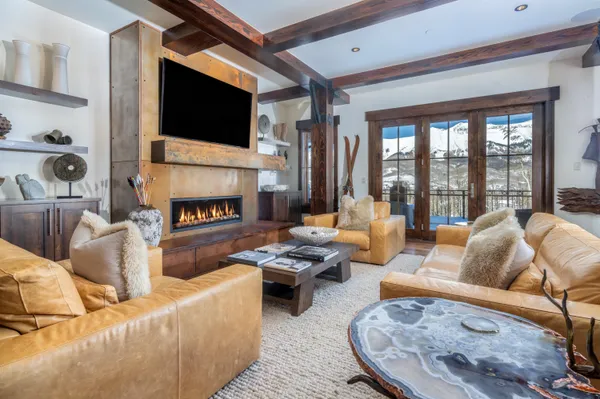 a living room with furniture fireplace and a flat screen tv