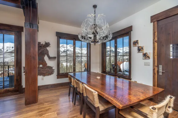 a view of a dining room with furniture wooden floor and chandelier