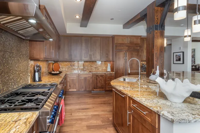 a kitchen with sink stove and cabinets