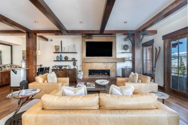 a living room with fireplace furniture and a flat screen tv