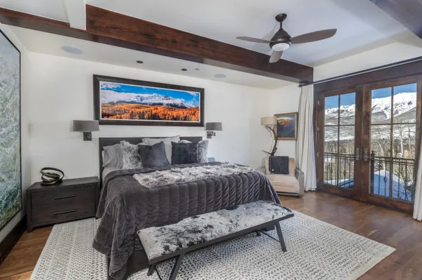 a bedroom with a bed and a large window