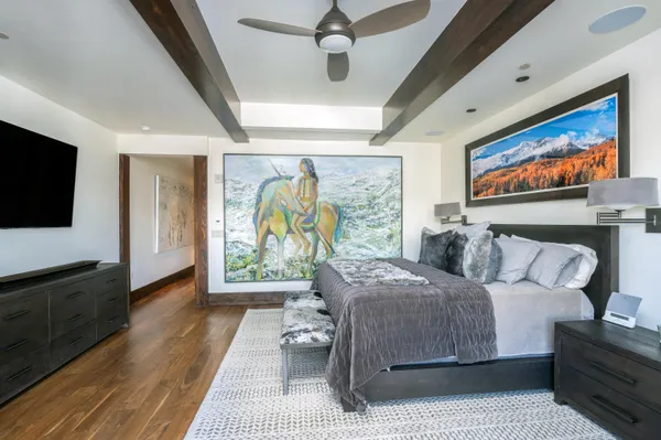a bedroom with a bed and a flat screen tv
