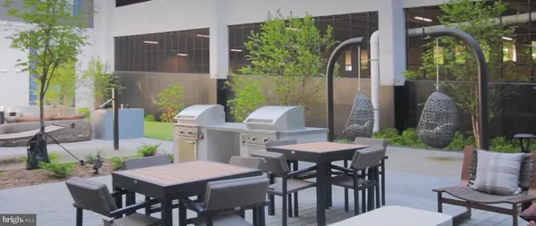 a outdoor dining space with furniture and a potted plant