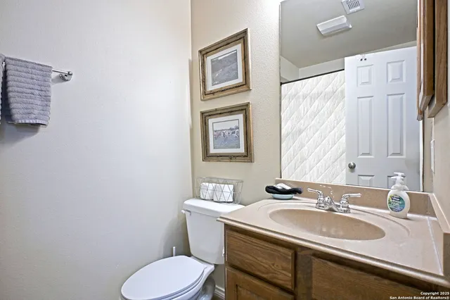 a bathroom with a sink toilet and a mirror