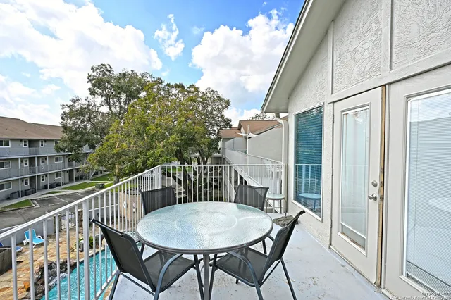 a view of balcony with furniture