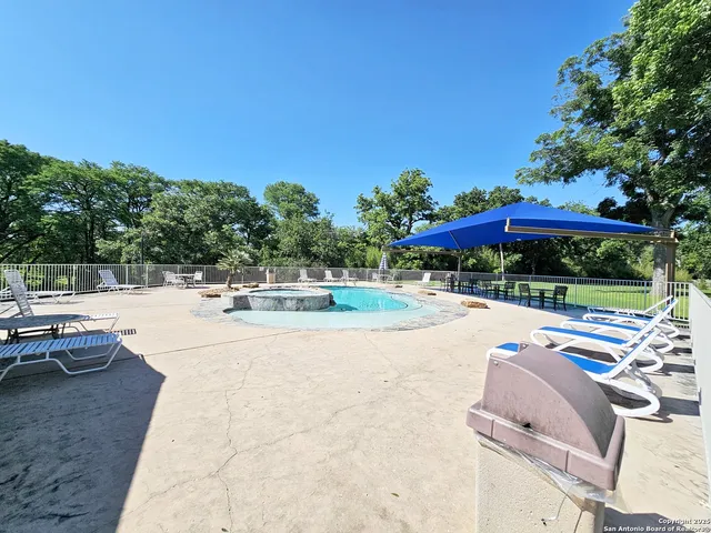 a view of outdoor space with swimming pool and furniture