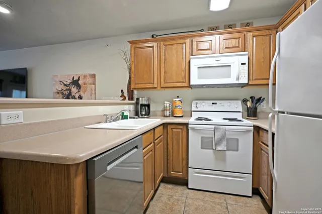 a kitchen with a sink stove and refrigerator