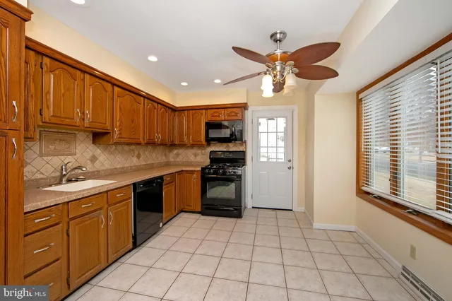 a kitchen with stainless steel appliances granite countertop a stove sink and cabinets