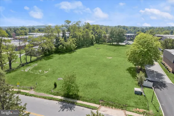 a view of a garden with a building in the background