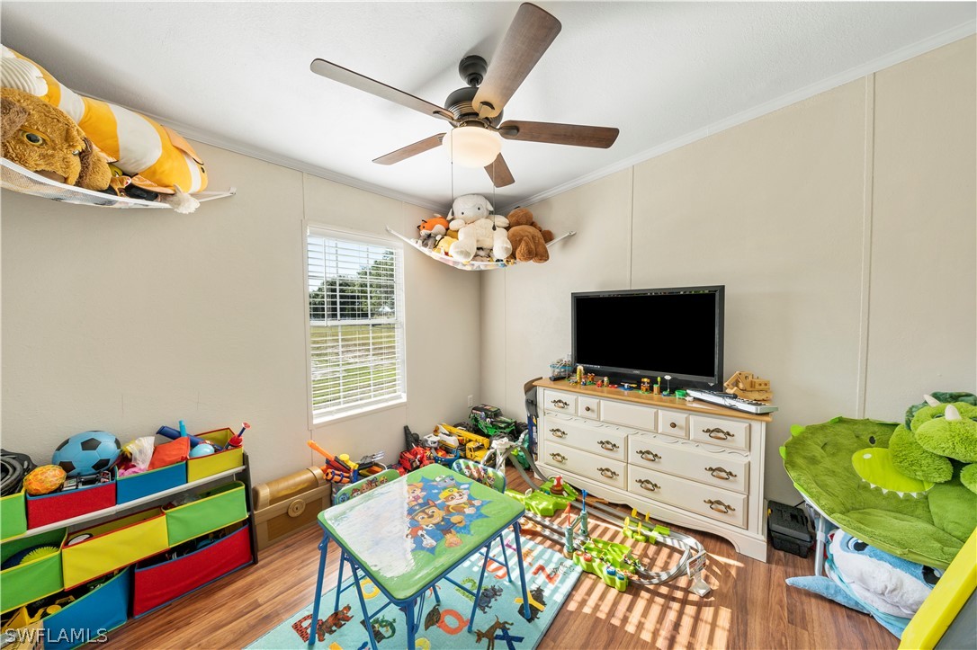 2401 Wendy Road Fort Denaud, FL 33935 - Photo 11 of 35 a bedroom with a bed and a flat screen tv
