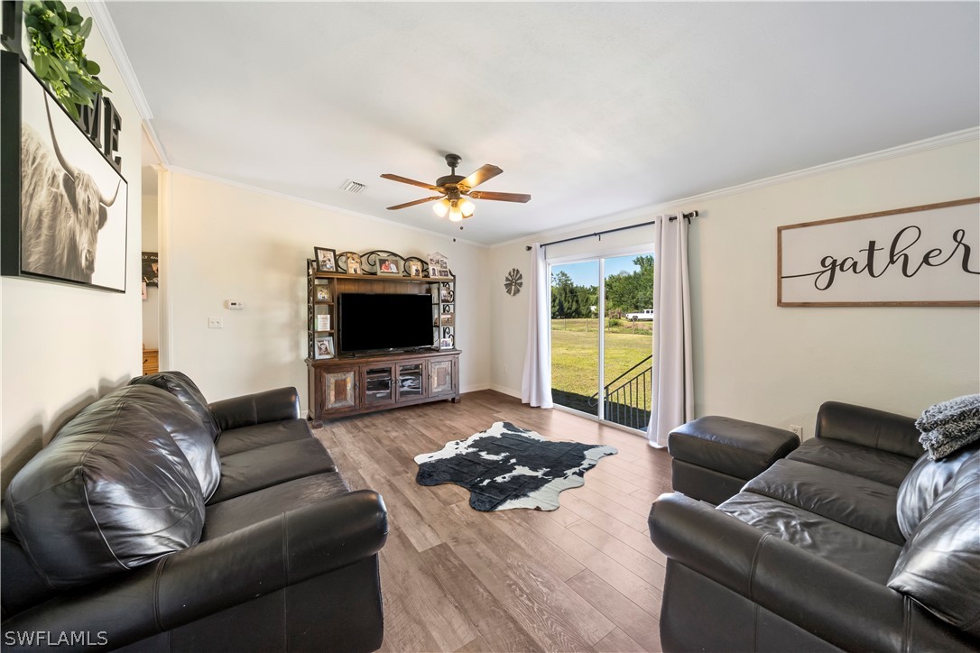 2401 Wendy Road Fort Denaud, FL 33935 - Photo 12 of 35 a living room with furniture and a flat screen tv