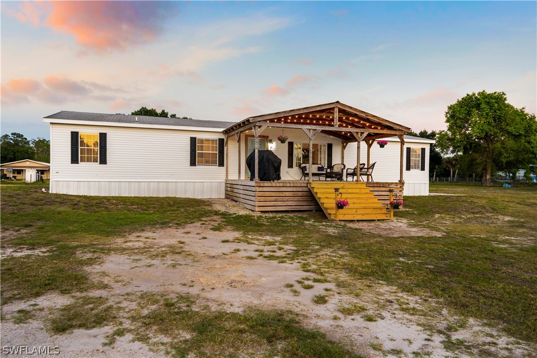 2401 Wendy Road Fort Denaud, FL 33935 - Photo 2 of 35 a front view of a house with a yard