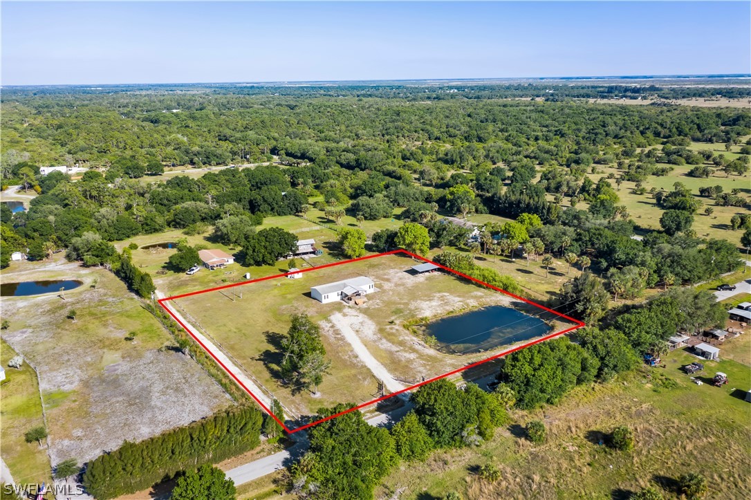 2401 Wendy Road Fort Denaud, FL 33935 - Photo 30 of 35 an aerial view of residential houses with outdoor space and trees