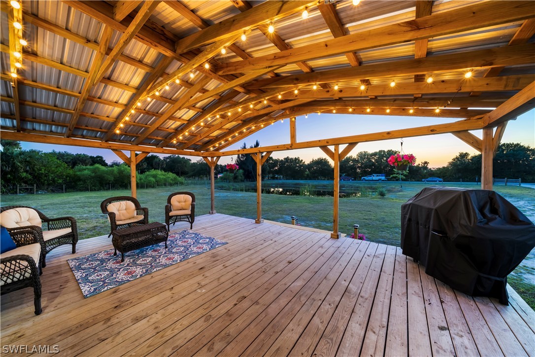 2401 Wendy Road Fort Denaud, FL 33935 - Photo 3 of 35 a view of a patio with couches and table under an umbrella