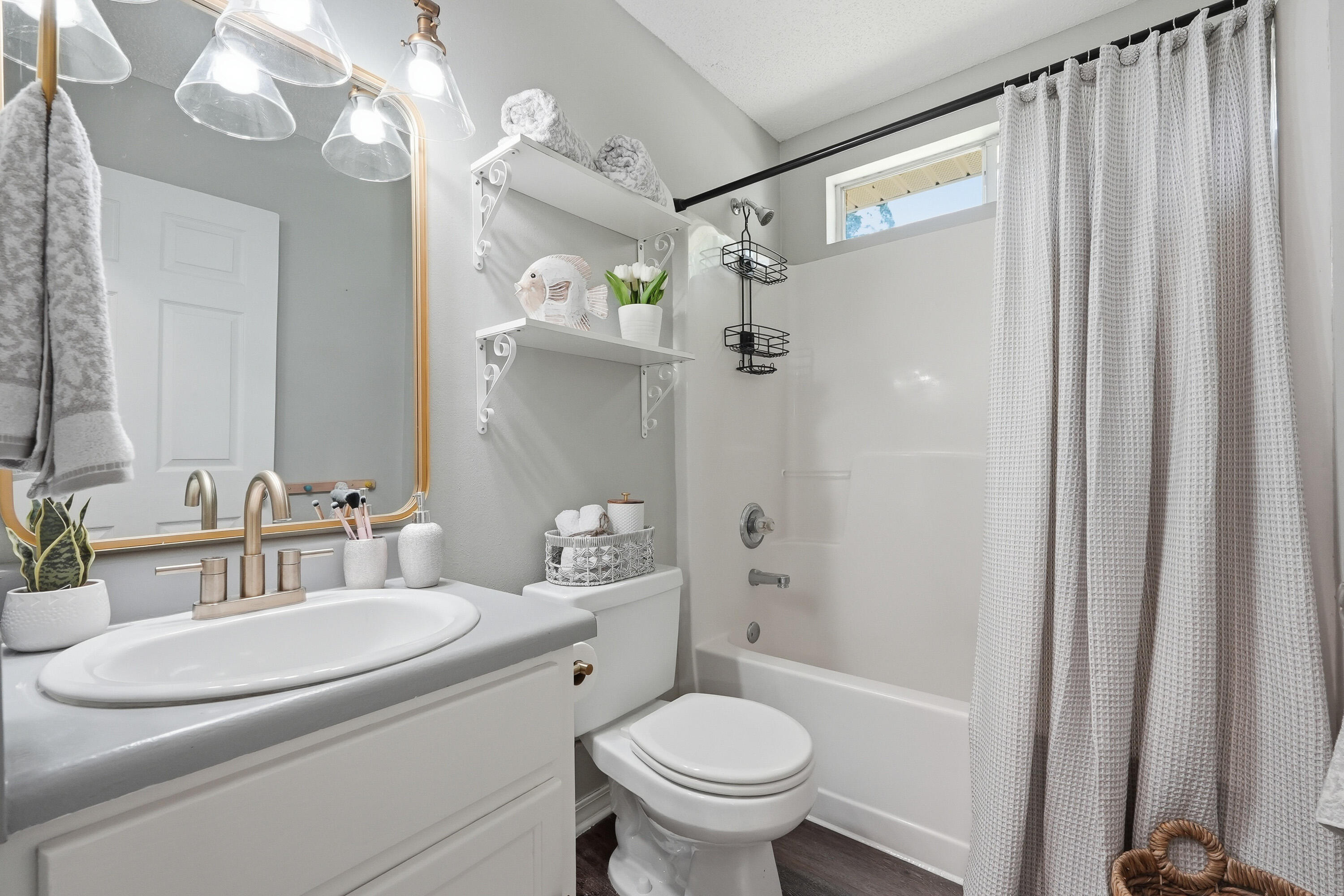 3033 Cabela Lane Crestview, FL 32539 - Photo 21 of 32 a bathroom with a sink a toilet a mirror and shower
